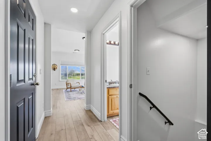 Wood-finish flooring throughout the hallway