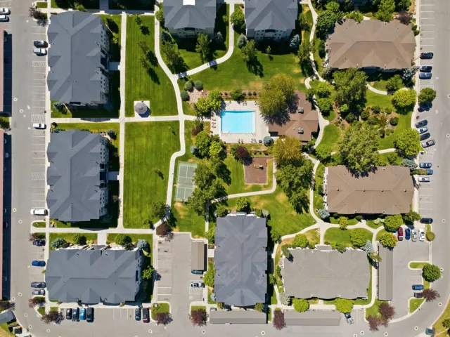 Landscaped grounds with a swimming pool, tennis court, and playground
