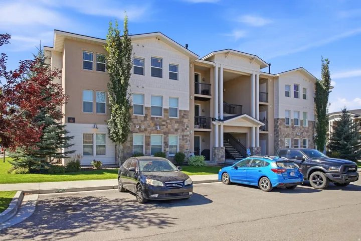 Multi-story building featuring stucco, stone, and horizontal siding finishes
