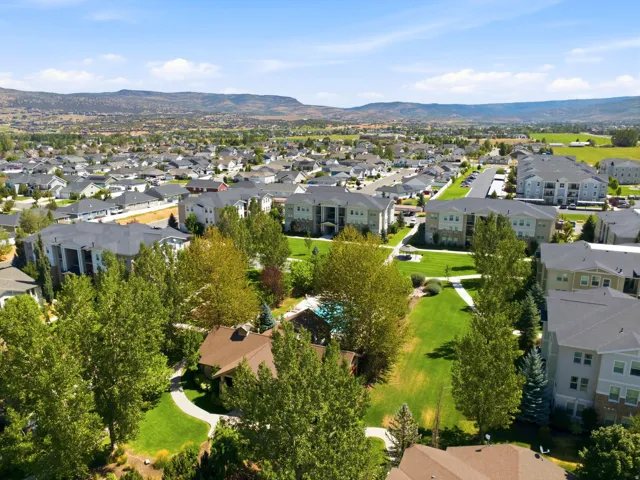 Community with green spaces and mountainous backdrop