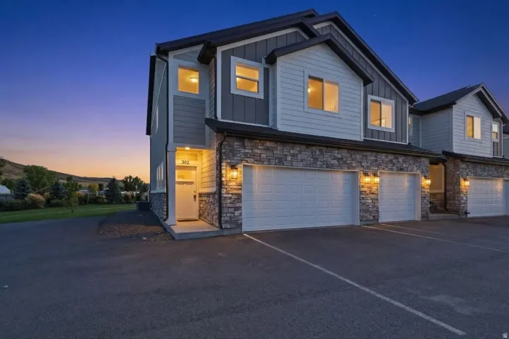 Stone and siding exterior with attached two-car garage