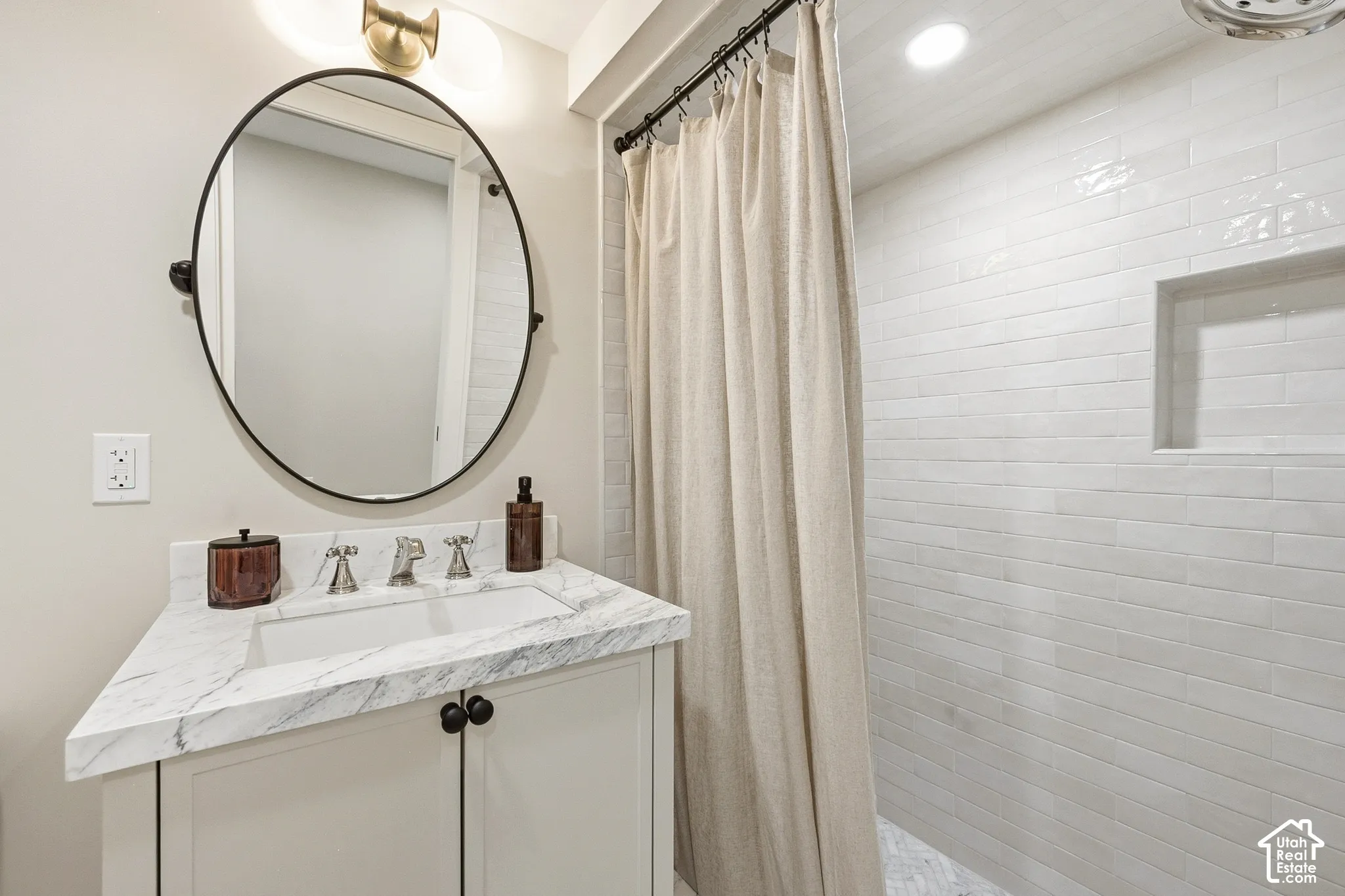 White subway tile and marble shower with recessed niche
