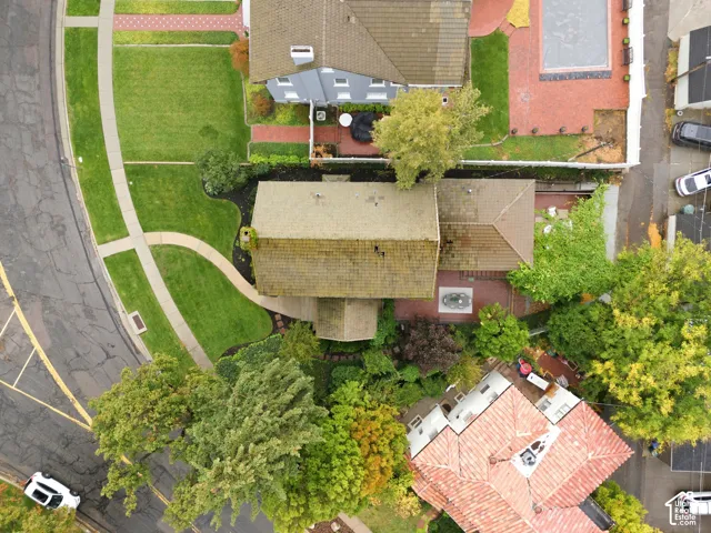 Aerial perspective showcasing the property's rooflines, surrounding green spaces, and mature landscaping