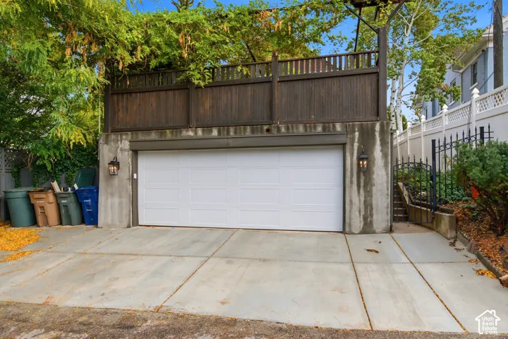 Concrete driveway leading to a two-car garage with a white sectional door