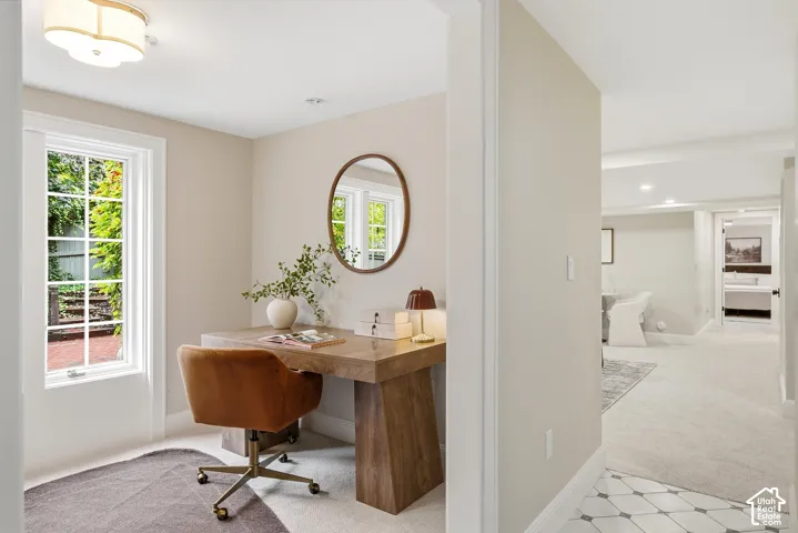 Recessed lighting and a decorative flush mount fixture illuminate the ceiling