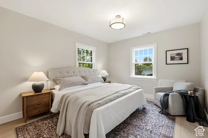 Third Bedroom. Light wood-finish flooring, white trim, and two double-hung windows