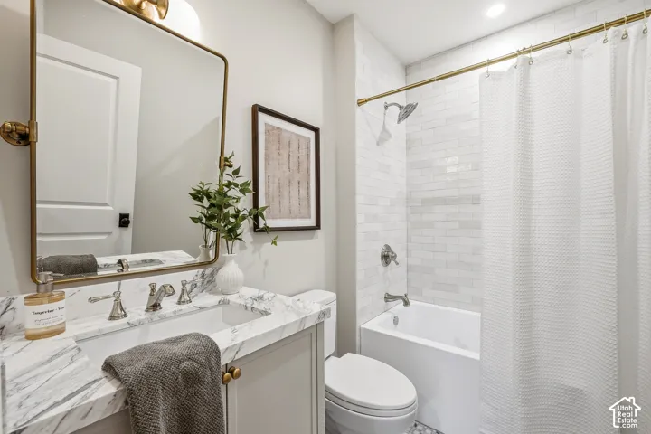 Hallway Full Bath. Marble-finish vanity with an undermount sink and brushed nickel faucet