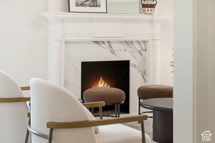 Fireplace with a white mantel and a natural stone surround