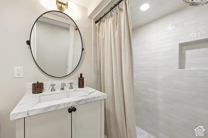 White subway tile and marble shower with recessed niche