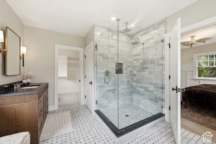 Glass-enclosed shower with marble surround and dual shower heads