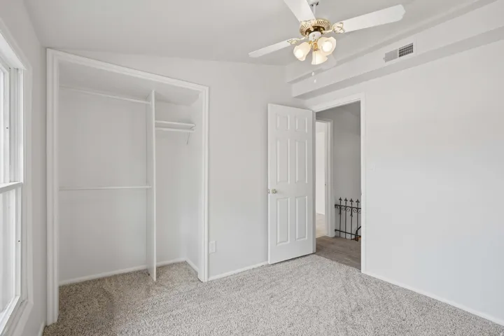 Built-in closet with shelving and hanging rods