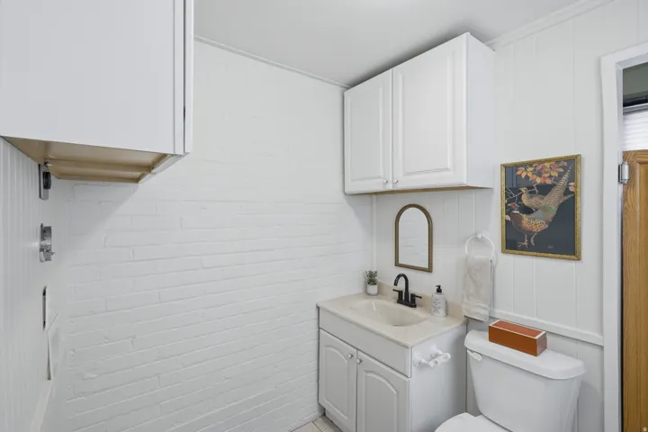 Vanity with an integrated sink, black faucet, and white base cabinetry