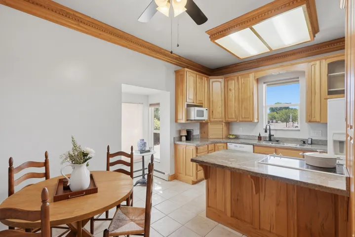 Kitchen featuring wood-finish cabinetry, light-toned countertops, and a built-in cooktop