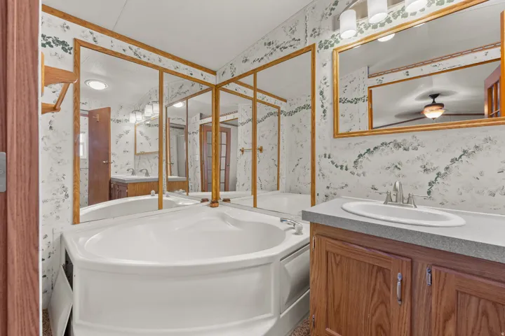 Large primary bathroom with double sinks and a soaker tub.