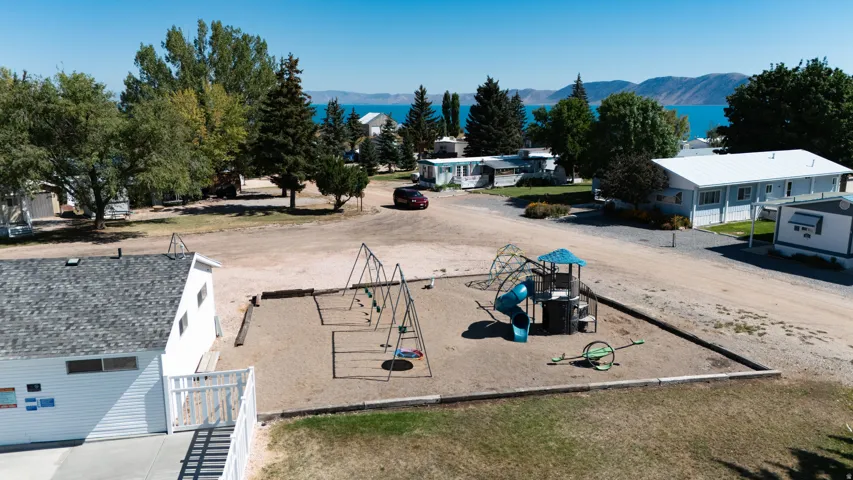 Community playground with swings, slide structure, and sand base