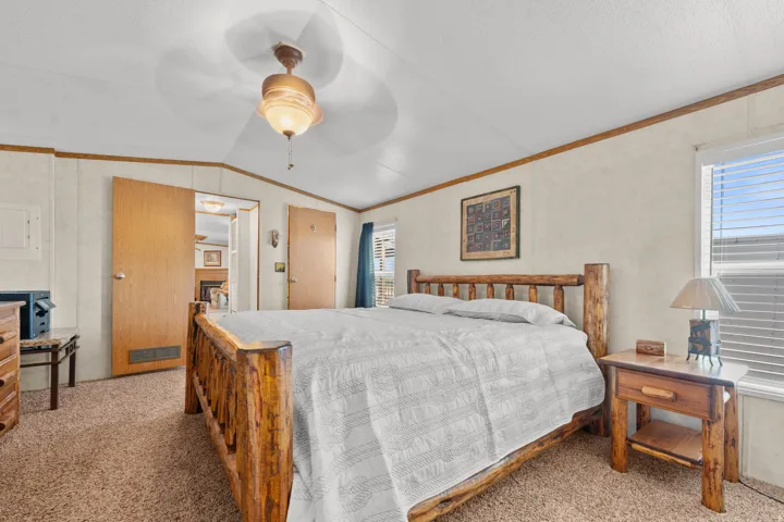 Large primary bedroom with ceiling fan.