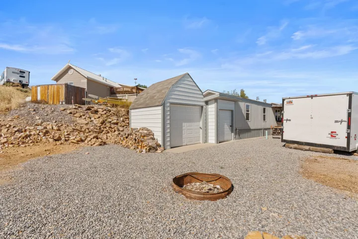 Plenty of parking, two storage garages, and a firepit.