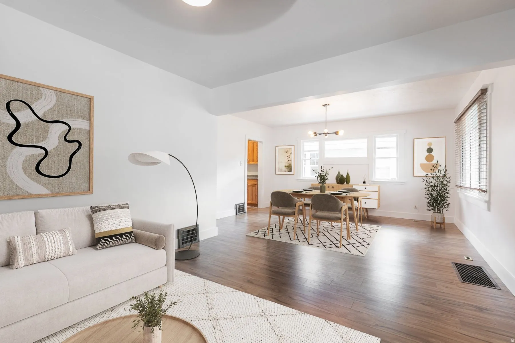 Wood-finish flooring throughout, white walls, and a recessed ceiling create a bright interior