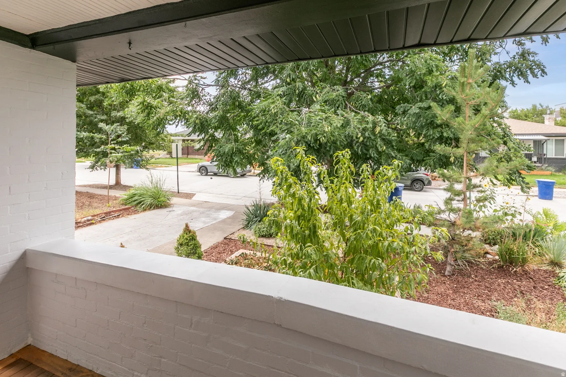 Covered porch with white painted brick and dark trim
