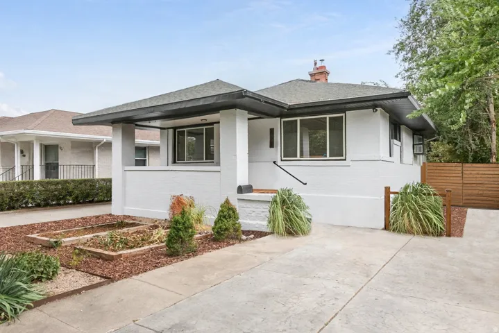 White brick exterior with a dark trim roofline