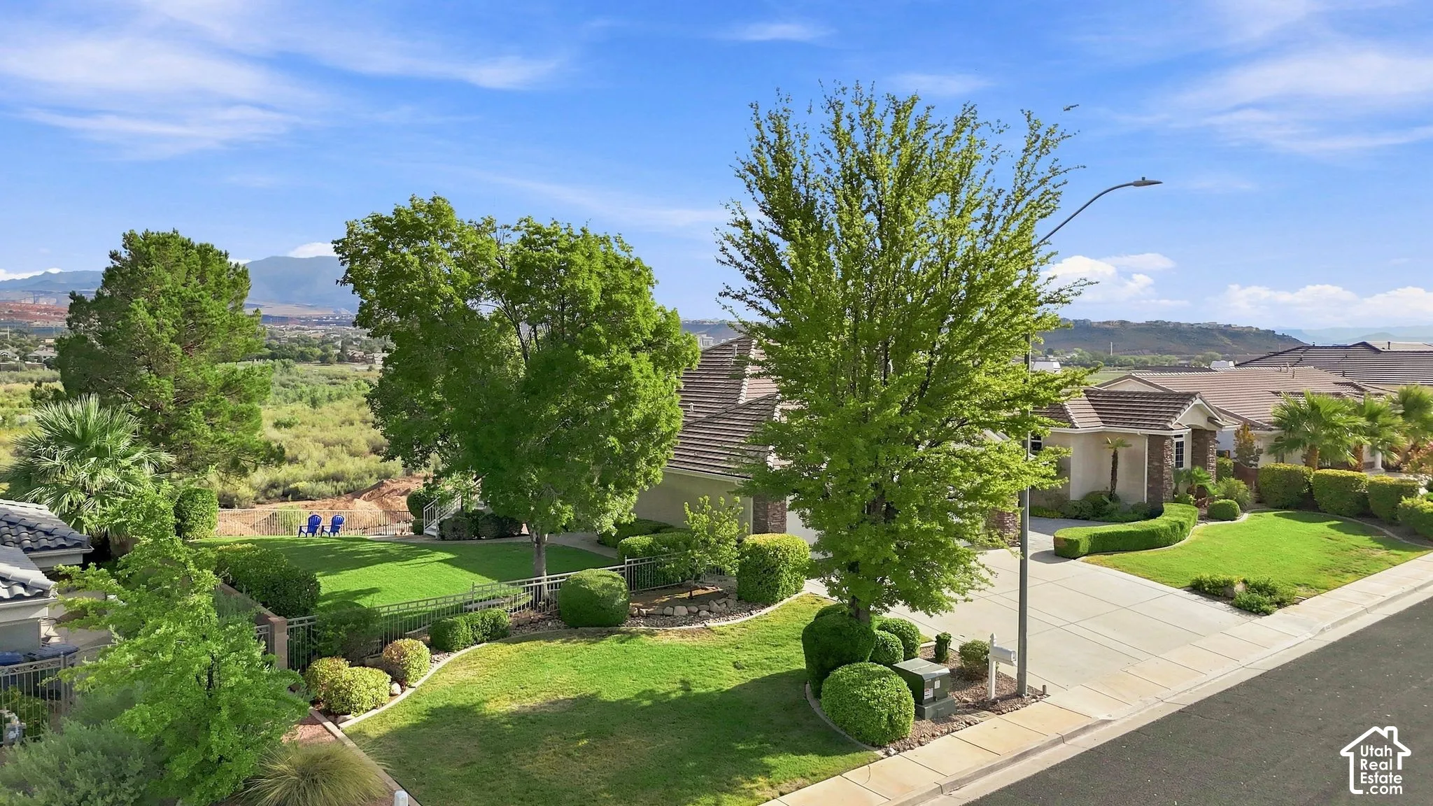 Mature landscaping with established trees and manicured lawn creates an inviting outdoor setting