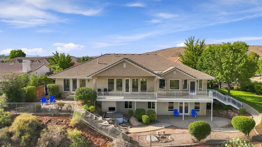 Multi-level rear exterior with extensive decking and a lower patio