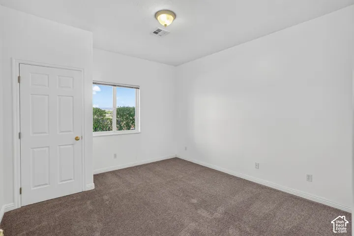 Bright interior with clean white walls, a single-pane window, and carpet flooring