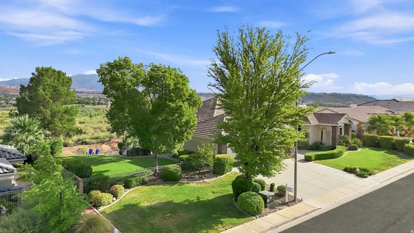 Mature landscaping with established trees and manicured lawn creates an inviting outdoor setting