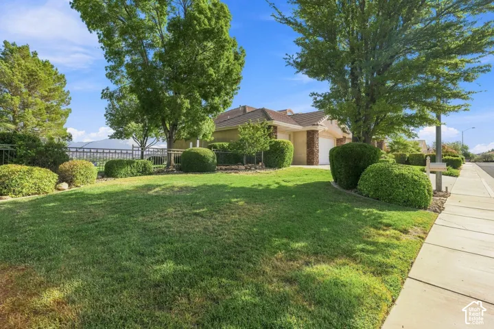 Expansive front lawn with mature trees and established landscaping