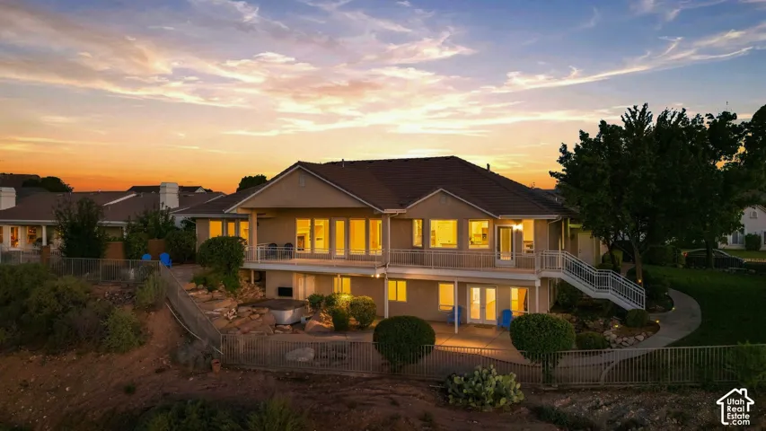 Multi-level residence featuring an upper deck and a lower patio