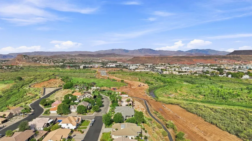 Residential neighborhood featuring winding streets, established landscaping, and distant mountain ranges