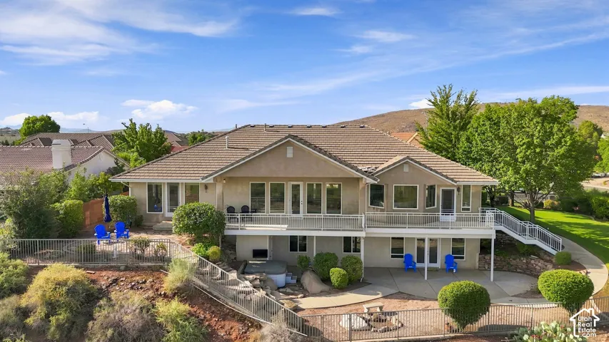 Multi-level rear exterior with extensive decking and a lower patio