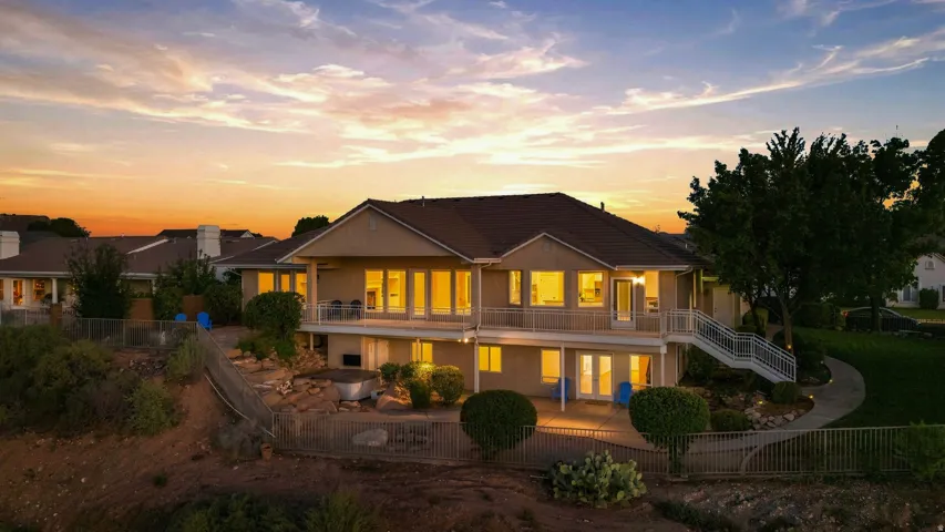 Multi-level residence featuring an upper deck and a lower patio