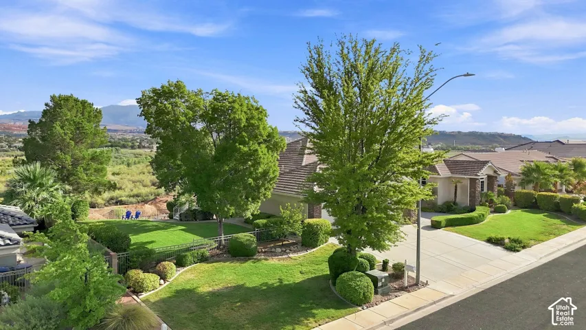 Mature landscaping with established trees and manicured lawn creates an inviting outdoor setting