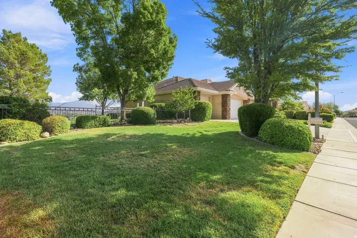 Expansive front lawn with mature trees and established landscaping