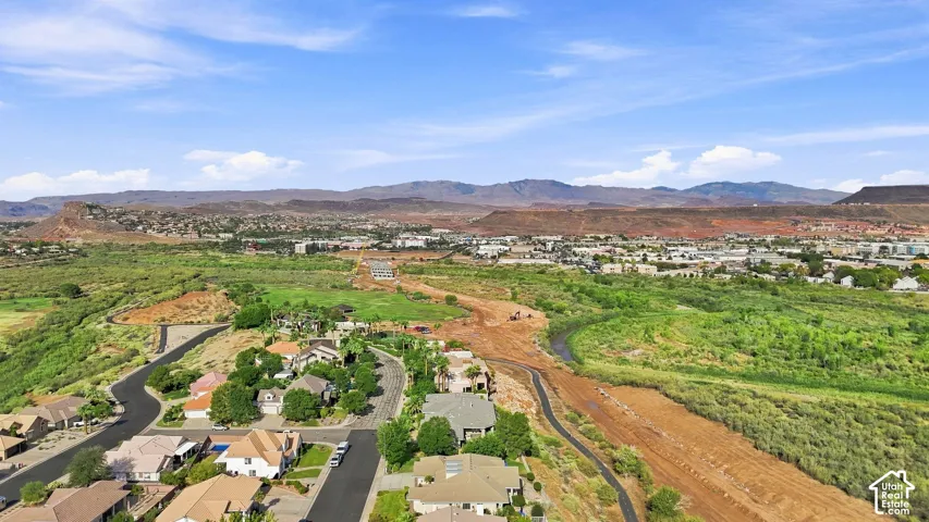 Residential neighborhood featuring winding streets, established landscaping, and distant mountain ranges