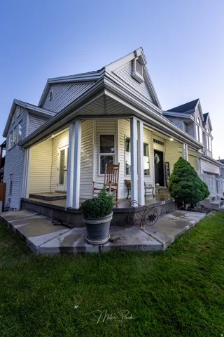 Multi-level porch featuring white columns and siding