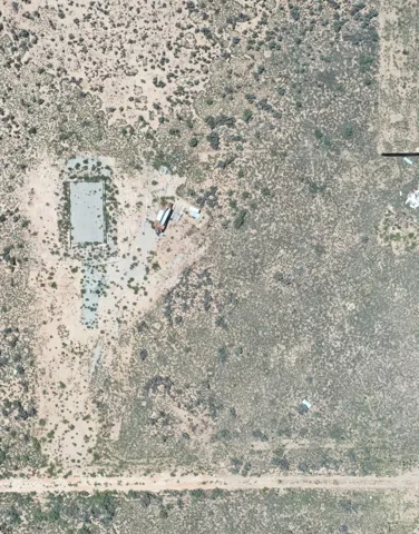 Aerial View. Showing the property with a structure and surrounding landscape