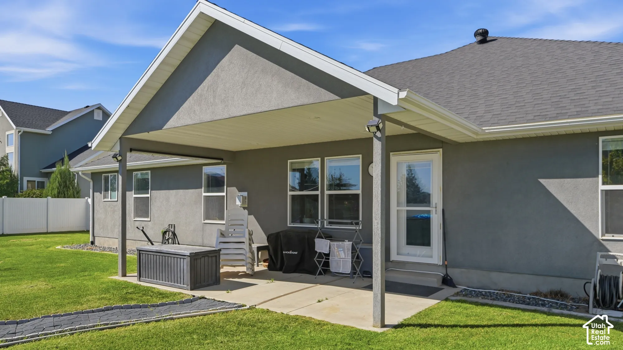 Covered patio featuring a concrete slab and multiple windows