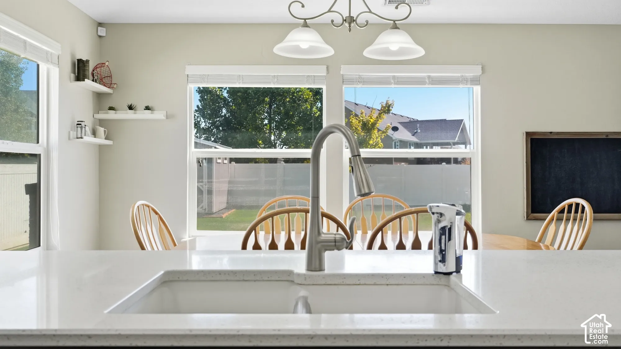 White solid surface countertop with an integrated sink and gooseneck faucet