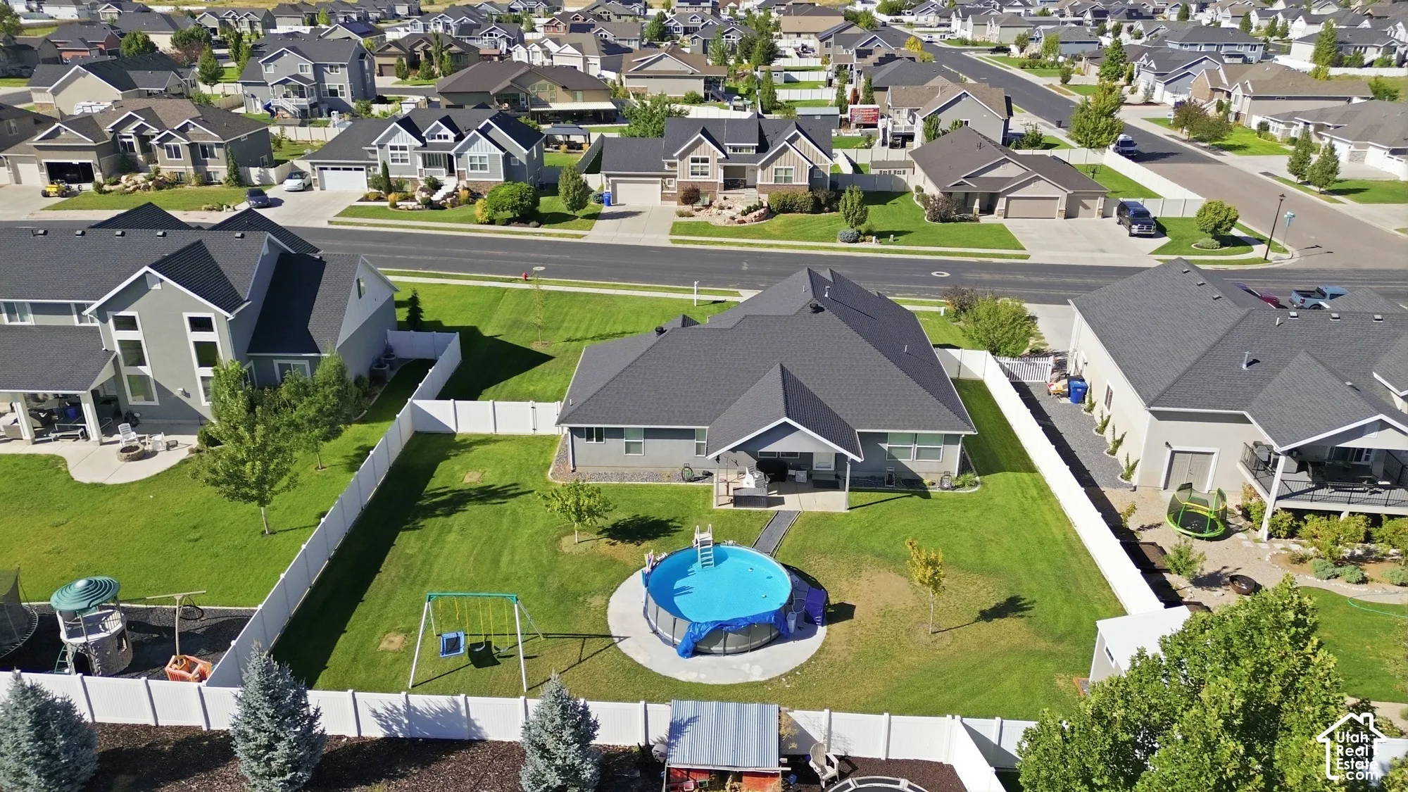 Expansive lot featuring a large lawn, privacy fencing, and an above-ground pool