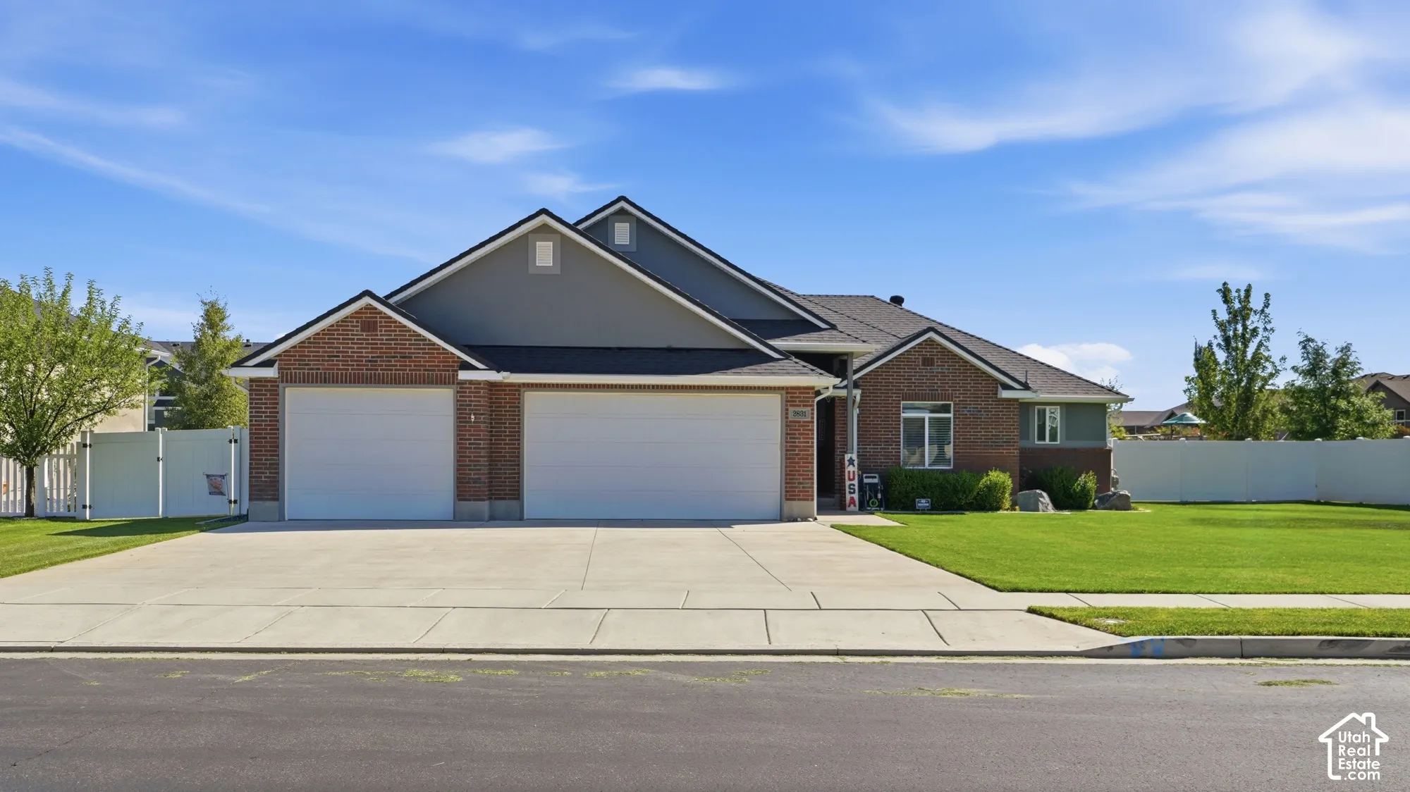 Brick and siding exterior with a multi-car garage