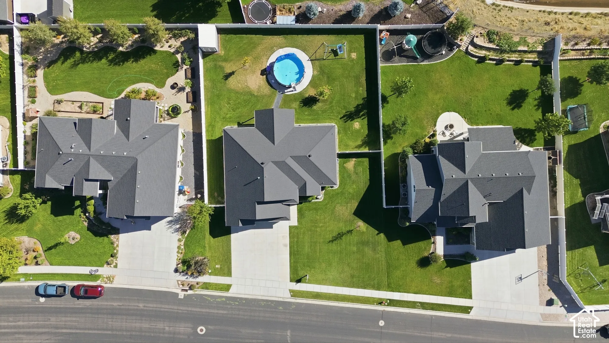 Expansive backyard featuring a manicured lawn, established landscaping, and a fenced perimeter