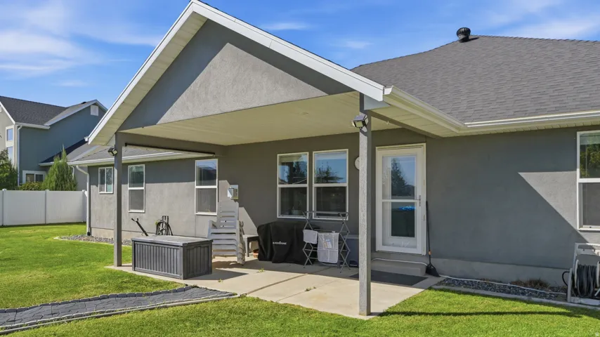 Covered patio featuring a concrete slab and multiple windows