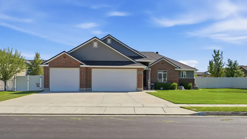 Brick and siding exterior with a multi-car garage