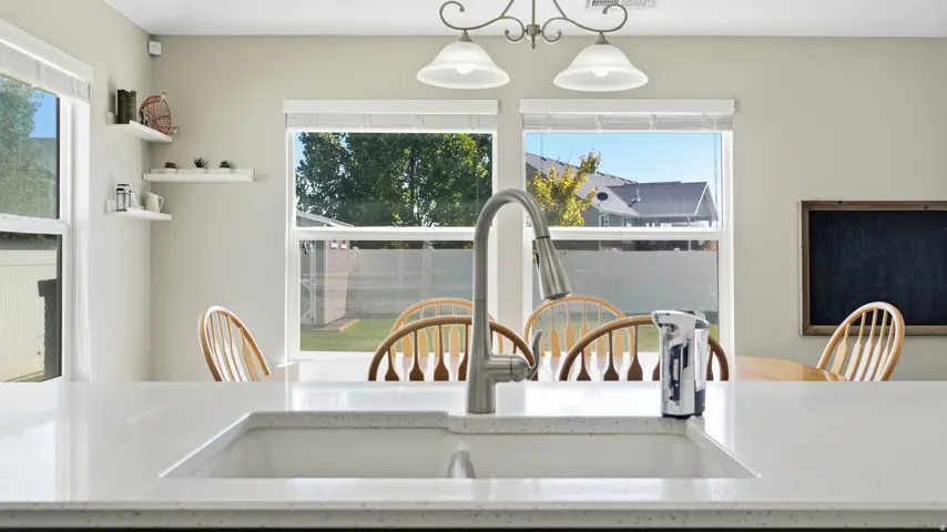 White solid surface countertop with an integrated sink and gooseneck faucet