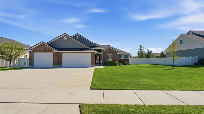 Brick veneer and siding exterior with dual garage doors