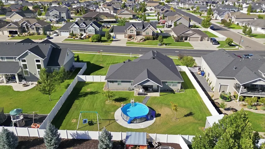 Expansive lot featuring a large lawn, privacy fencing, and an above-ground pool