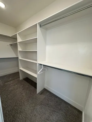 Custom closet organization system with integrated shelving and chrome hanging rods