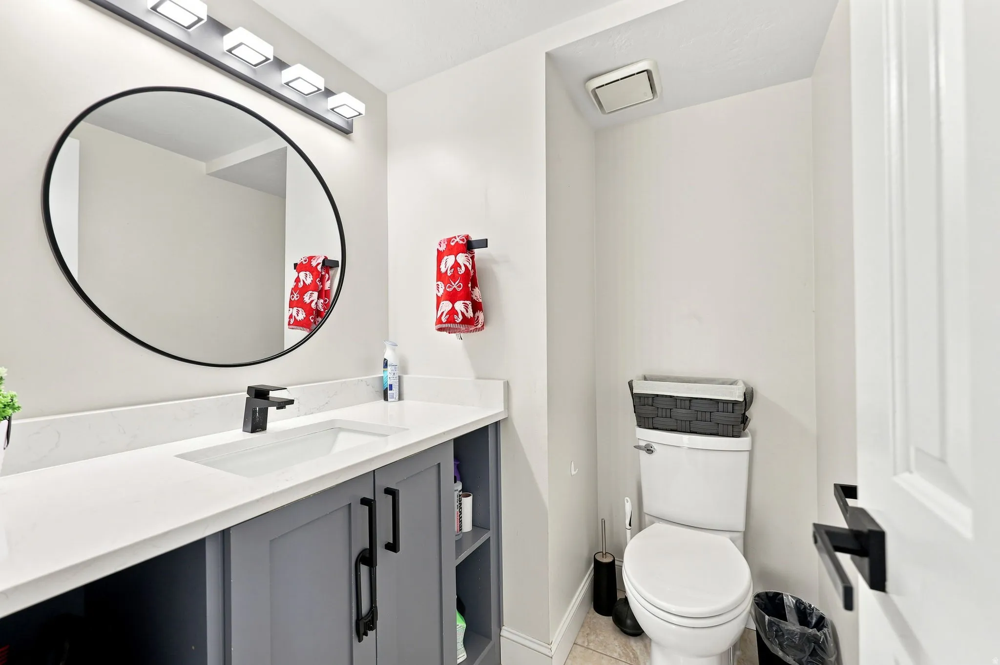Modern vanity with an integrated rectangular sink, matte black faucet, and a large round mirror